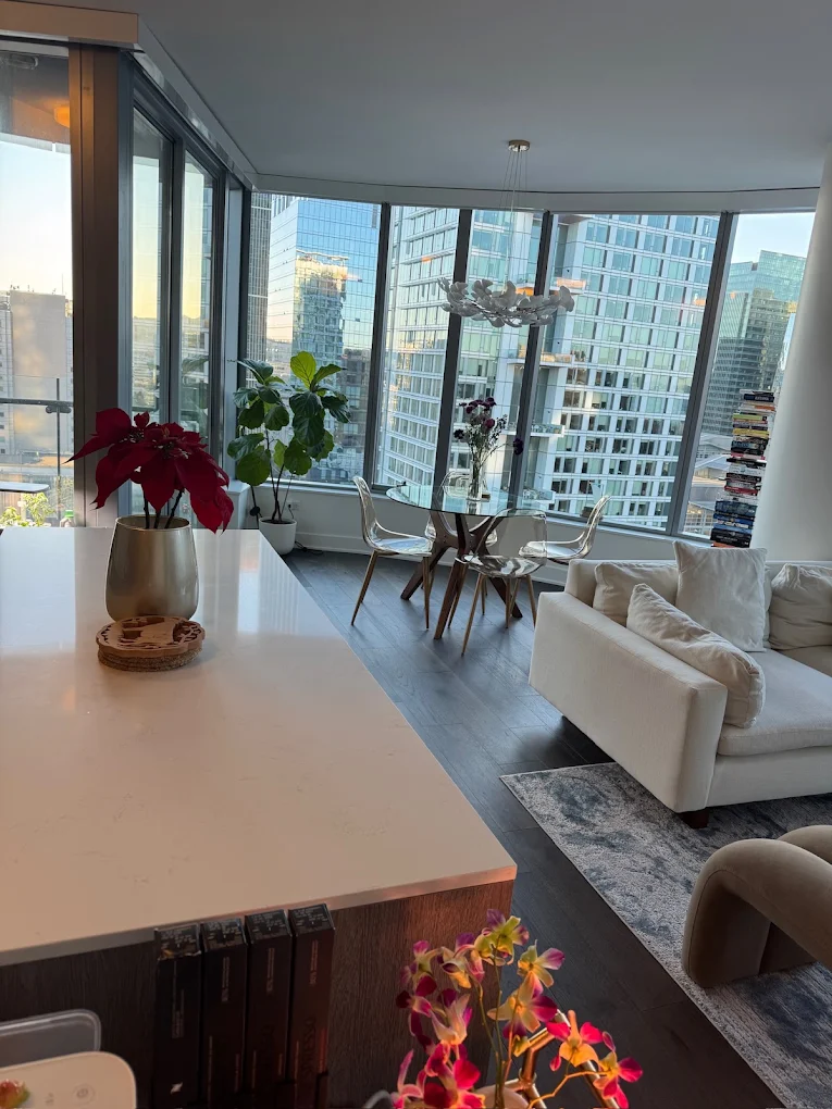 Open kitchen island and living area with city windows