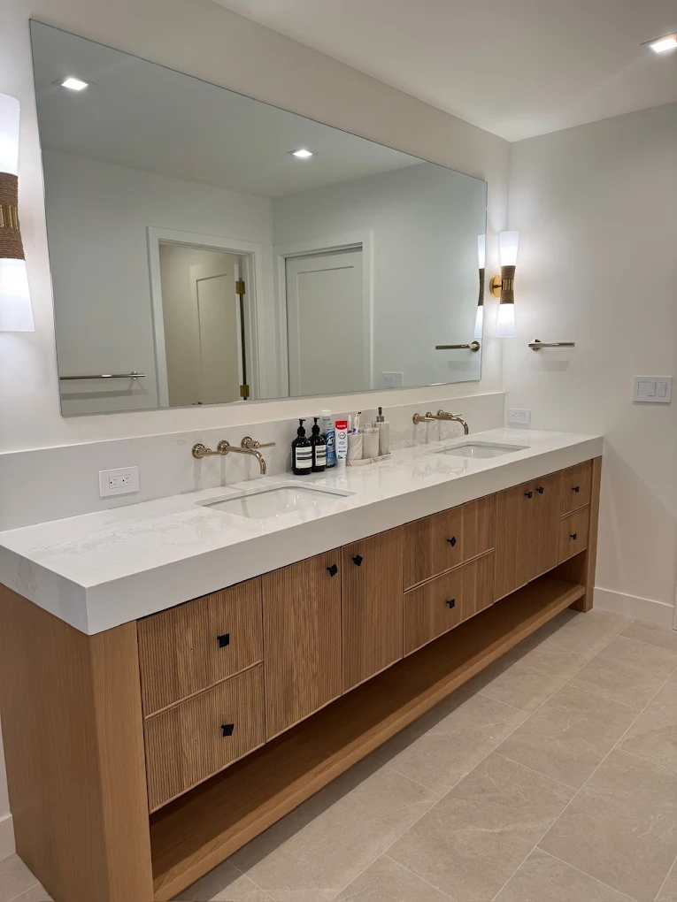 Long bathroom vanity with double sinks and wood cabinets