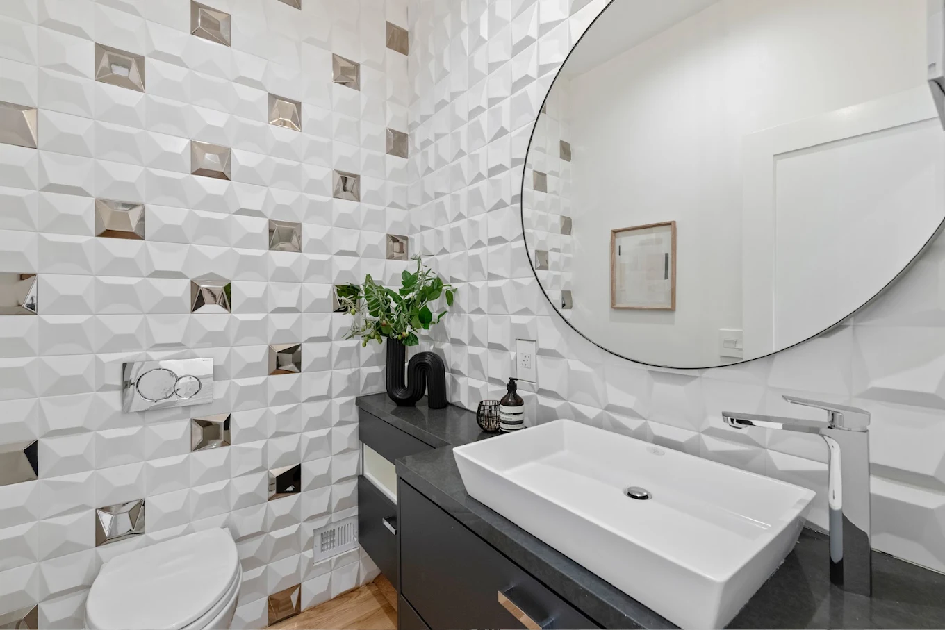 Bathroom with round mirror, vessel sink and textured white tile